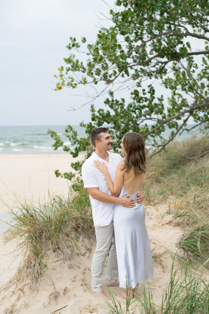 couple chest to chest and smiling during their Muskegon engagement photo session