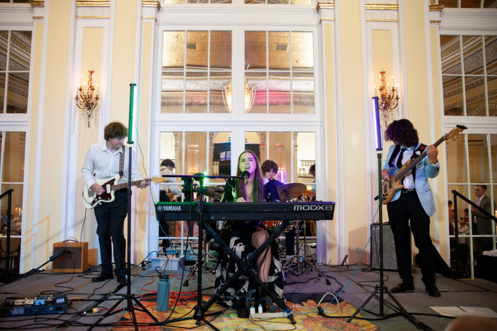 Sophia and the Sages band performing live at a wedding inside the ballroom of the Amway Grand Plaza Hotel