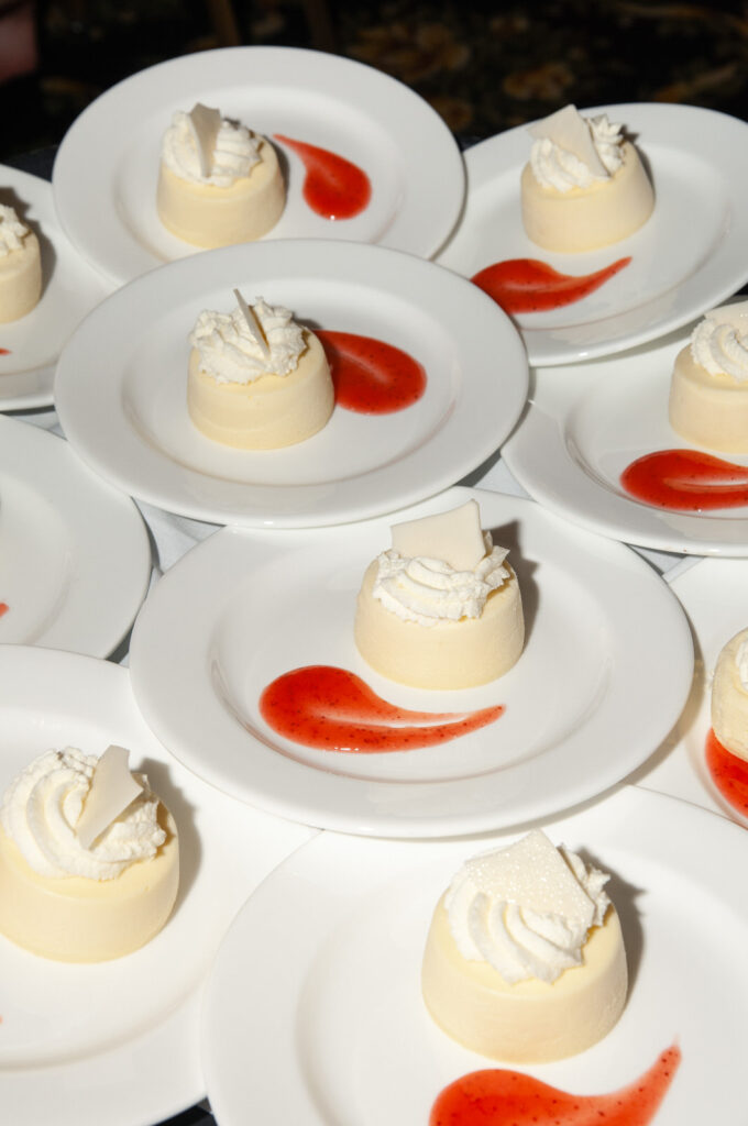 individual cheesecakes with strawberry drizzle for wedding guests