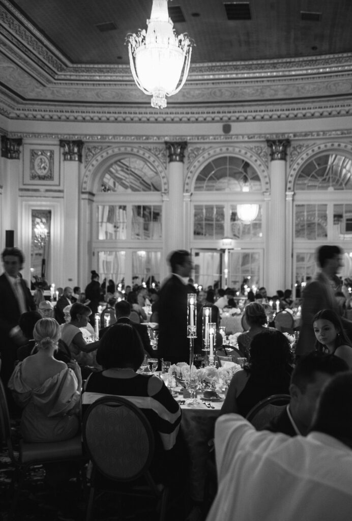 guests enjoying a timeless wedding reception inside of the Amway Grand Plaza Hotel in downtown Grand Rapids