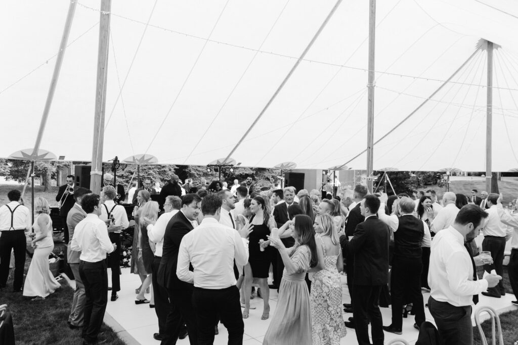 wedding guests dancing and partying under a sailcloth tent on a Michigan summer evening