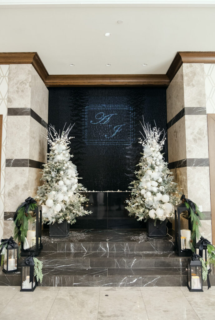 The entrance of the Meridian in Farmington Hills, Michigan decorated for a winter wedding with Christmas trees