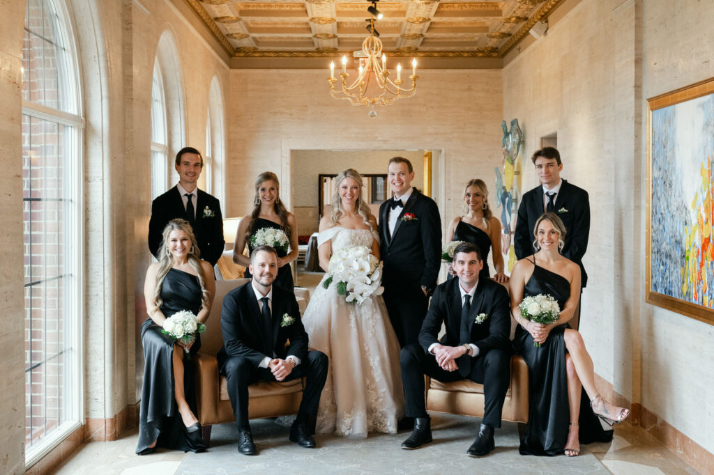 bride and groom with their eight person bridal party in all black at Saint John's Resort