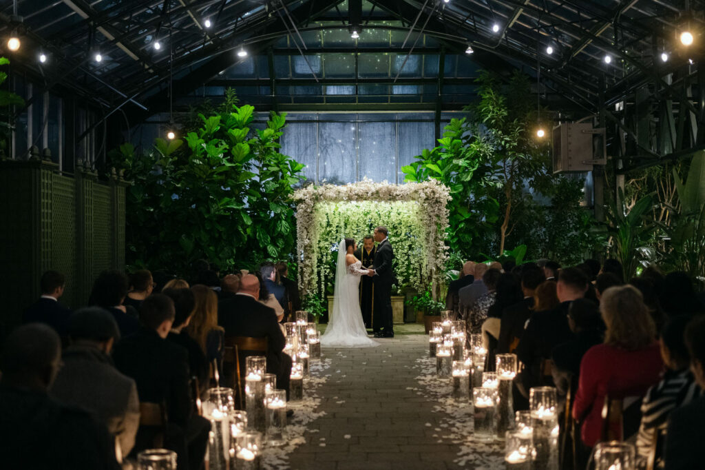 Bride and groom exchanging vows at Planterra Conservatory wedding