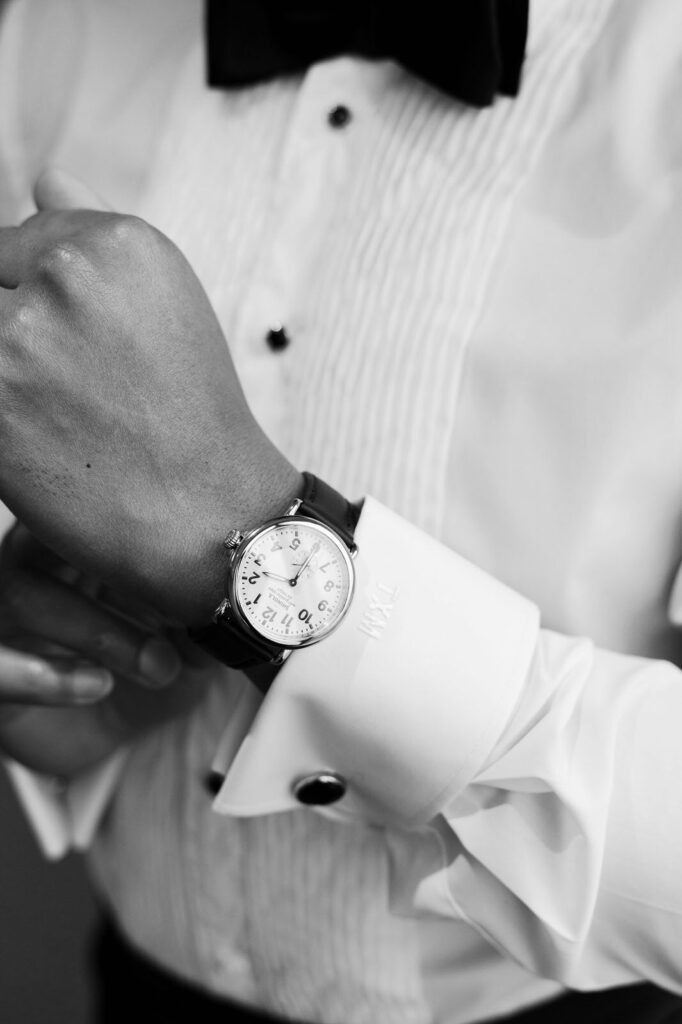 groom adjusting the Shinola watch on his wrist on his Detroit wedding day