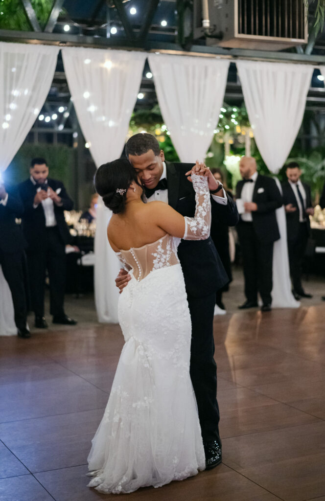 bride and groom dance during their winter wedding at Planterra Conservatory in West Bloomfield, MI