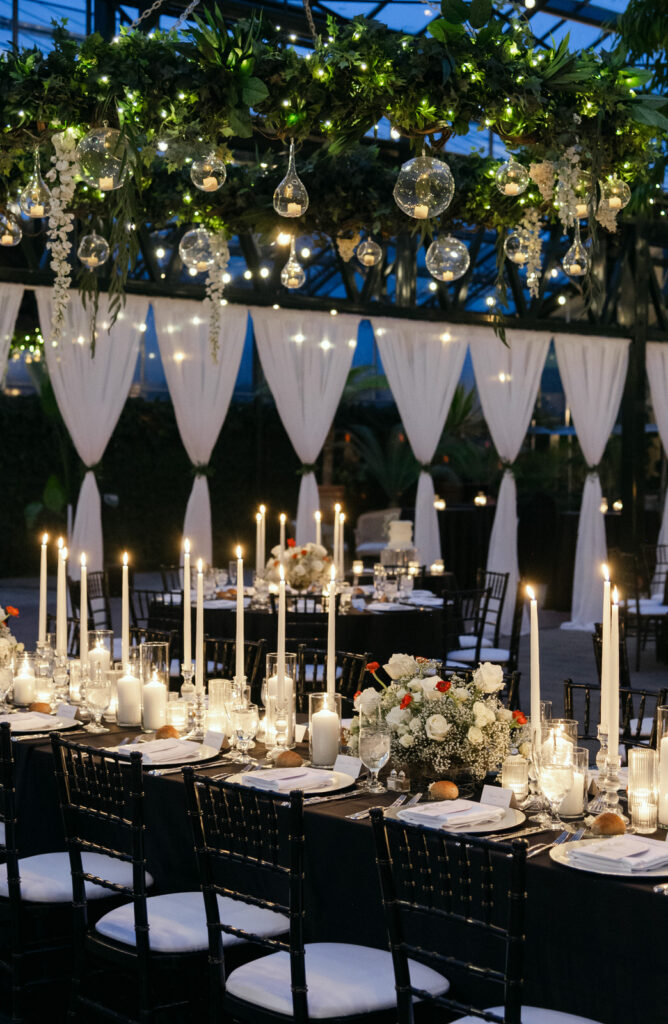 candlelit wedding reception decor with black table cloths and white candles during a winter wedding at Planterra