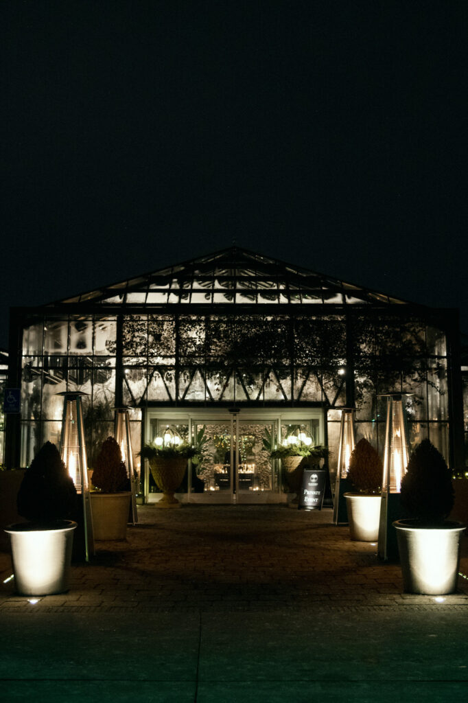 the exterior of Planterra Conservatory lit up at nighttime during a winter wedding