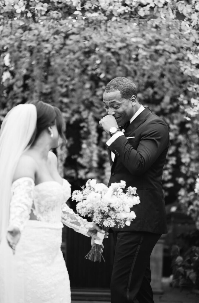 groom in pure shock and awe after seeing his bride for the first time on their wedding day at Planterra