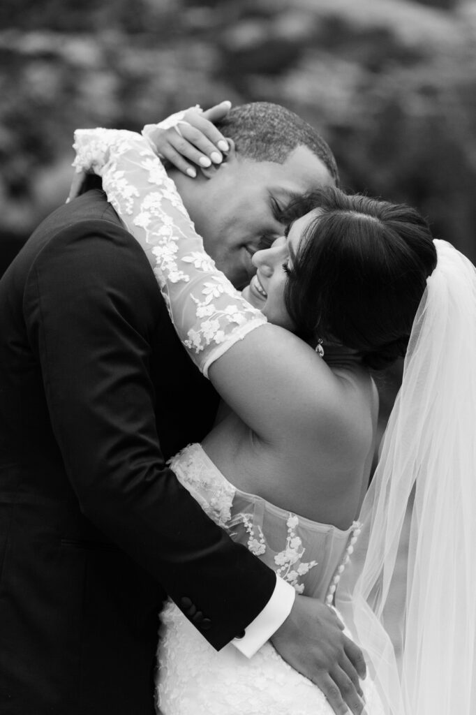 Sydney and Tristan embrace with their arms around each other for a sweet candid moment after their first look on their wedding at Planterra