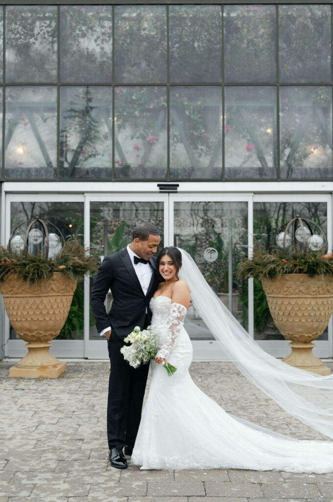 Winter wedding at Planterra Conservatory. Bride and groom in wedding attire standing outside of Planterra's venue.