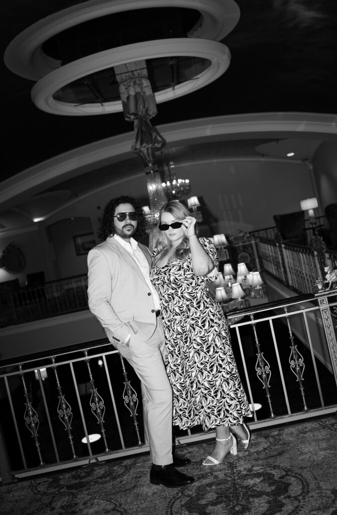 engaged couple with sunglasses on on the balcony of the amway grand plaza hotel