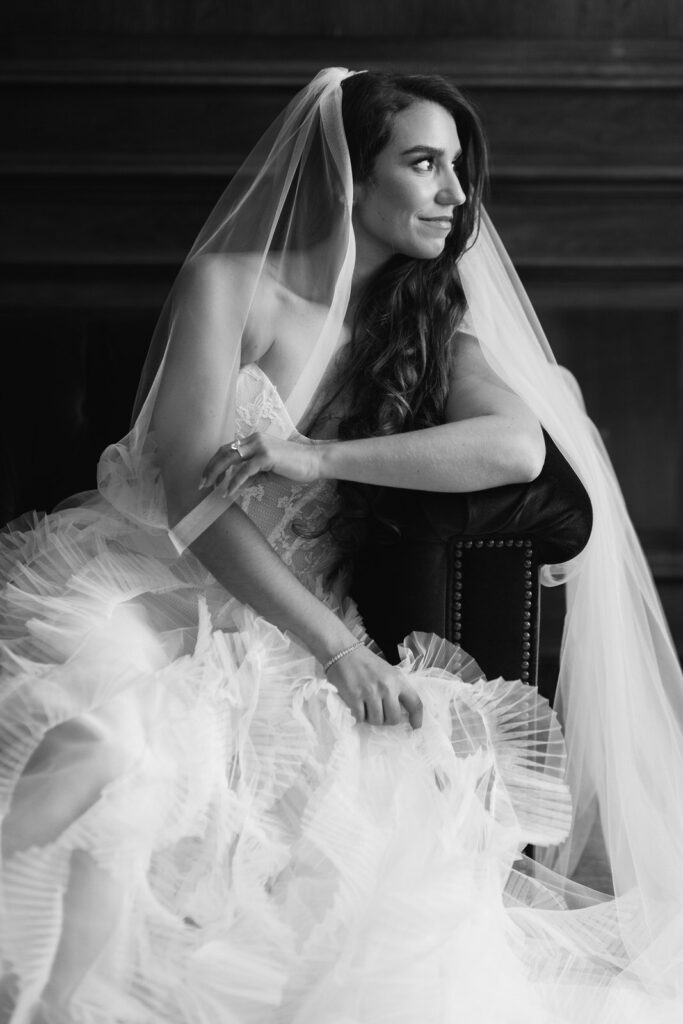 bride sitting on a couch in her suite of the Detroit Foundation Hotel