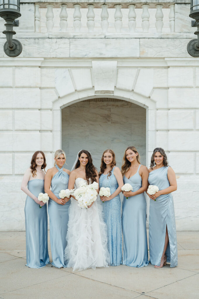 bride and her five bridesmaids in light blue dresses at the Detroit Institute of Arts on an August summer day