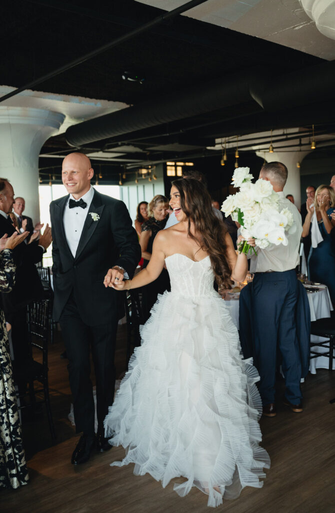 bride and groom make their grand entrance into their wedding reception at Chroma Detroit