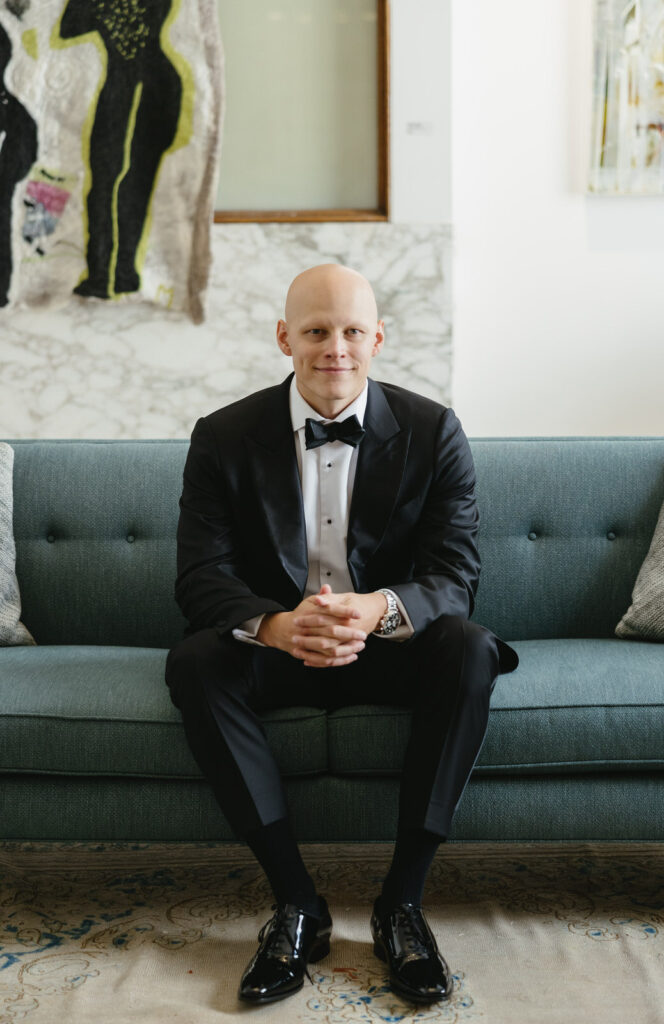 groom sitting on a green couch