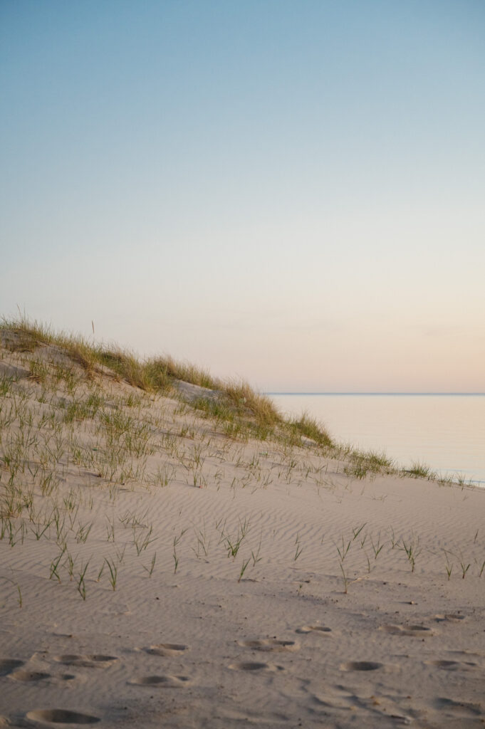 Grand haven State park sand dunes at sunset with the Lake Michigan horizon