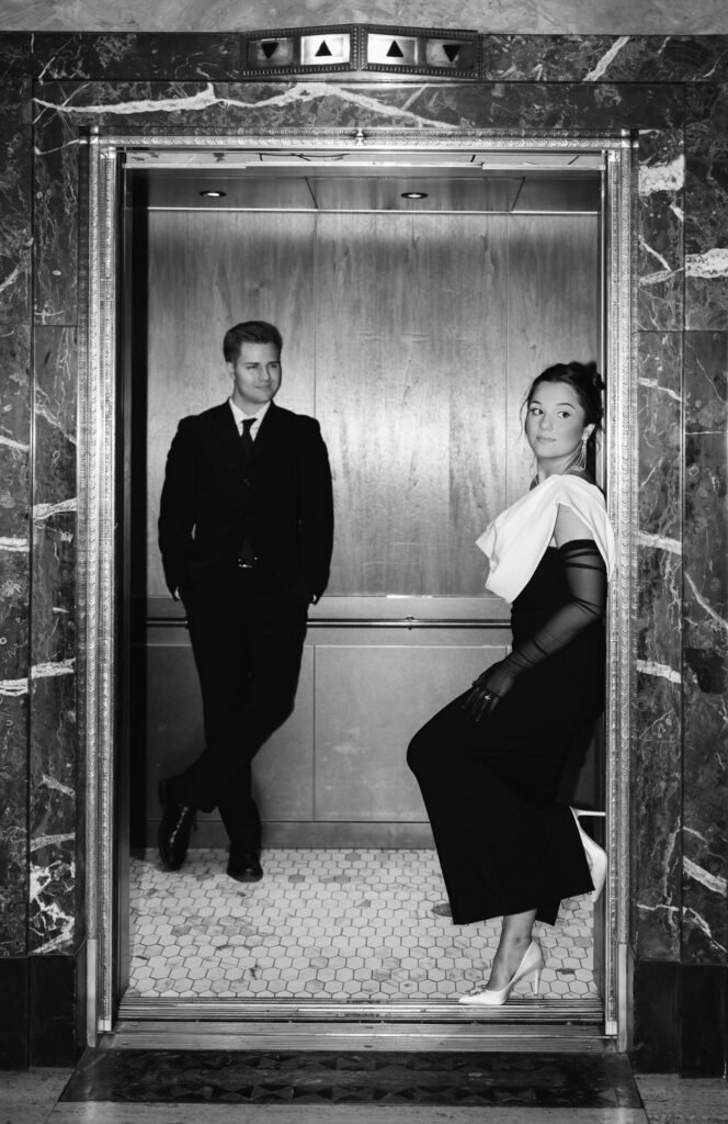 couple in black tie attire inside the elevator of the Fillmore Building in downtown Detroit