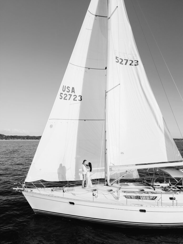 a couple embraces on a sailboat on Lake Michigan