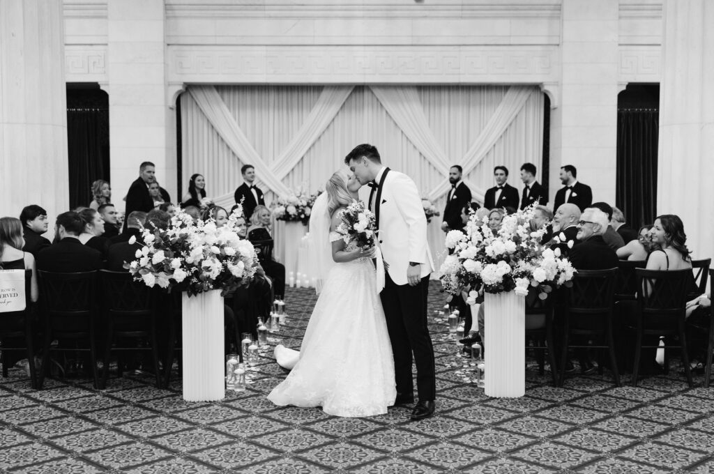 bride and groom kiss after their wedding ceremony at the Ballroom at McKay wedding venue in Grand Rapids