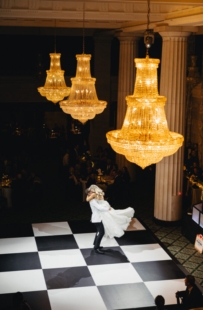 groom lifts and twirls his bride after their first dance at the Ballroom at McKay