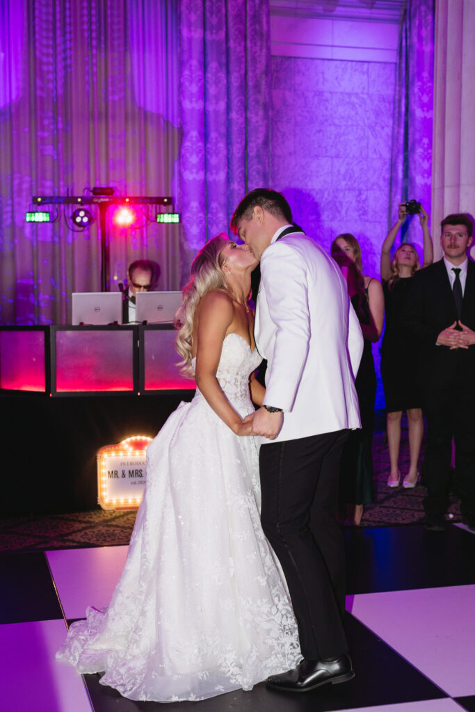 bride and groom kiss on the dance floor during their wedding reception at the Ballroom at McKay