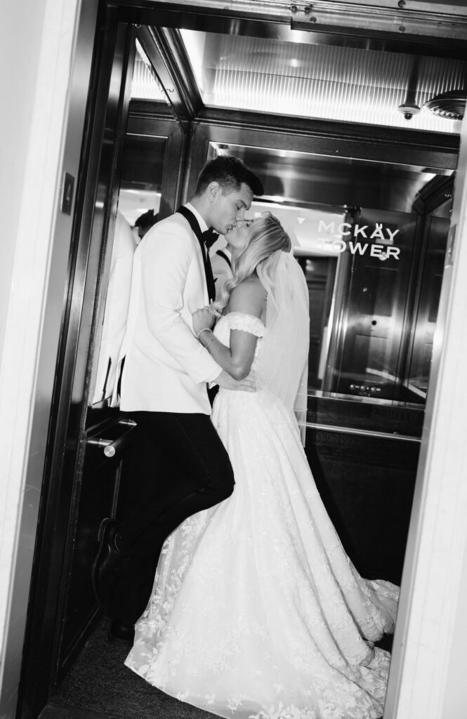 bride and groom kiss inside the elevator at the Ballroom at McKay in Grand Rapids, Michigan